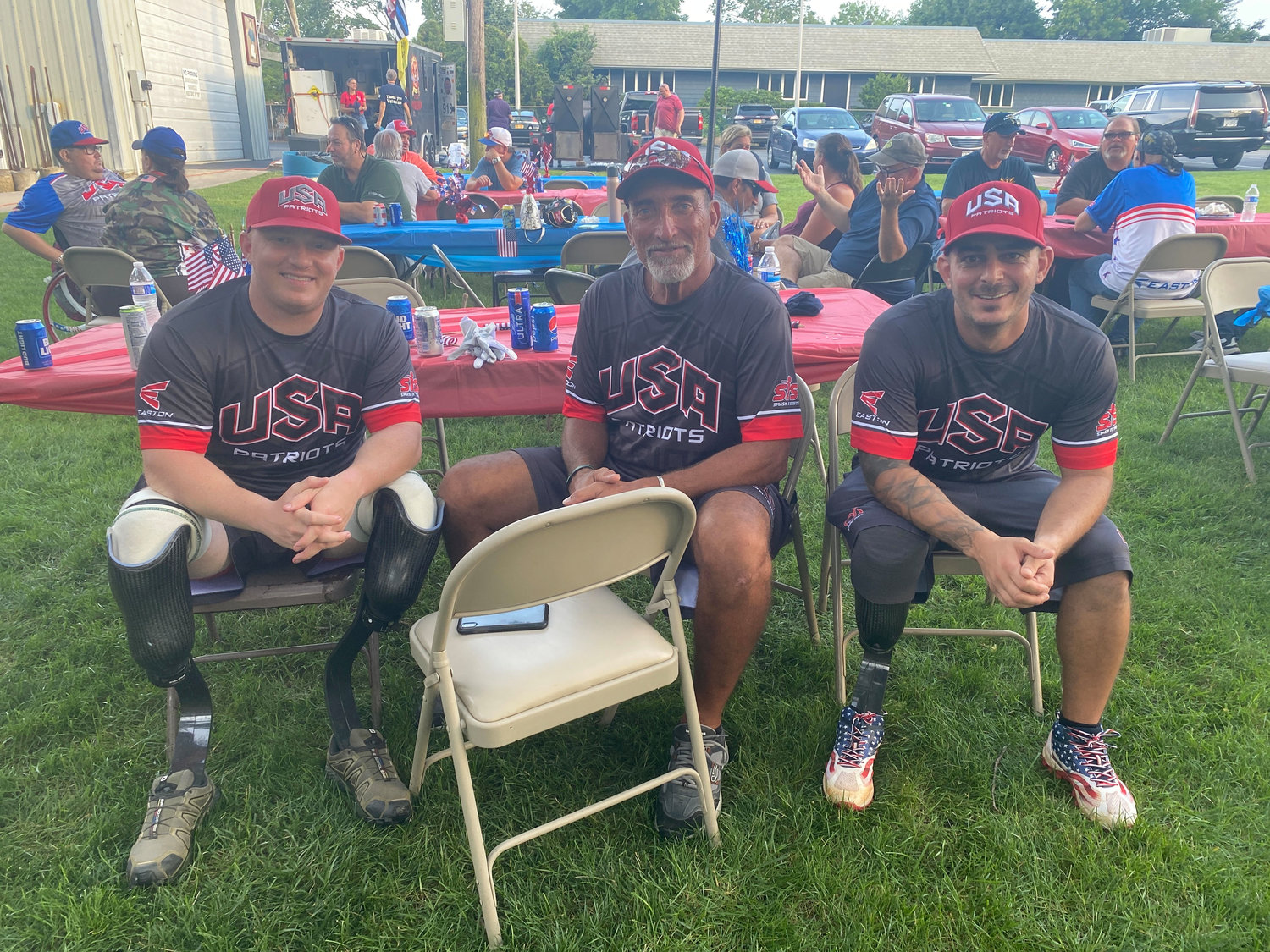 Players Josh Wiege, Kai Schjang and Nick Salerno at an outdoor barbecue held after the game at the Blue Point Fire Department.